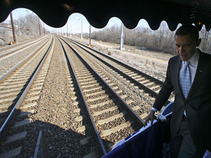Barack Obama stands on the back of his train car en route to Wilmington, Deleware on Saturday
(Photo: Reuters)