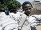 A child poses next to free food aid bags in the village of Doukoukoune, near Maradi, central Niger in 2005(Photo: AFP)