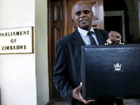 Patrick Chinamasa holds up a briefcase containing the government's budget at the Parliament buildings in Harare(Credit: Reuters)
