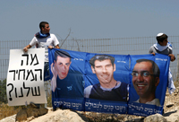 Israeli protesters with a poster of captured Israeli soldiers Ehud Goldwasser (R), Eldad Regev (C) and Gilad Shalit (L) during a demonstration last year(Photo: Reuters)