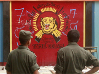 Sri Lankan soldiers and a Tamil Tiger mural in Mullaitivu.(Photo: Reuters)