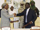 Sudanese rebel Justice and Equality Movement (JEM) representative Jibril Ibrahim (R) shakes hands with Amin Hassan Omar, a member of the Sudanese government delegation (Photo: Reuters)