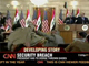 A still from the pool video (CNN) showing President Bush (podium, left) ducking the shoes (top right)(Photo: AFP)