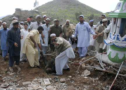 Pakistani tribesmen recover a body from the debris at the site of suicide blast near Jamrud in the Khyber agency(Photo: Reuters)
