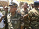 Madagascan Defence Minister Mamy Ranaivoniarivo (L) walks past soldiers in Madagascan capital Antananarivo on Tuesday(Photo: Reuters)