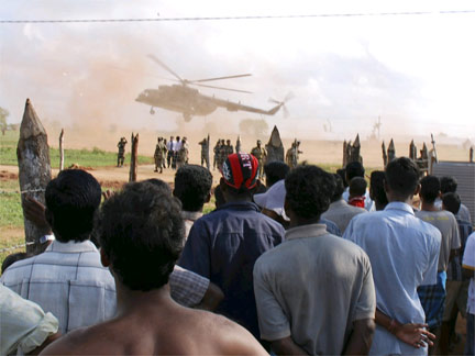 Internally displaced ethnic Tamils look at a helicopter take off over an internally displaced camp in Vavuniya(Photo: Reuters)