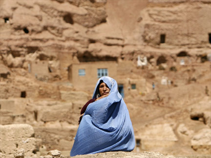 A woman sits in front of her home in Bamiyan province.(Photo: Reuters)