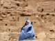 A woman sits in front of her home in Bamiyan province.(Photo: Reuters)