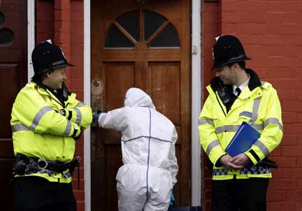 A forensic officer enters a house in Manchester(Photo: Reuters)