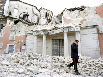 An Italian military carabinieri walks past destroyed buildings after the earthquake, in downtown Aquila(Photo: Reuters)