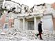 An Italian military carabinieri walks past destroyed buildings after the earthquake, in downtown Aquila(Photo: Reuters)