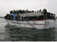 A boat overflowing with migrants, which survived a violent storm, arrives in the port of Tripoli 29 March 2009.(Photo: Reuters)