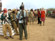 Somali militants stand guard as internally displaced people await food aid in Torotow on 13 April 2009(Photo: Reuters)