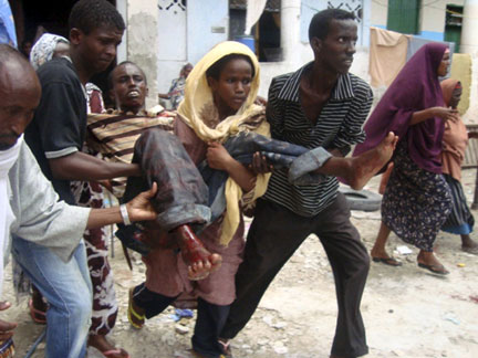 Somalia residents carry a wounded man to hospital after a mortar attack in the capital on Saturday.(Photo: Reuters)