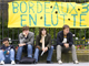 French university students sit beneath a banner in Bordeaux.(Photo: Reuters)