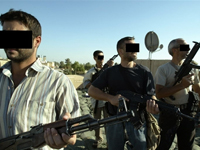 Iraqi and foreign mercenary members of a private security company stand on the rooftop of a house in Baghdad on 18 September 2007.( Photo: AFP )