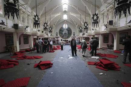 Officials and relatives of victims at the blast site in the Assumption Church in Kathmandu, 23 May 2009(Photo: Reuters)