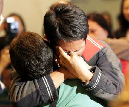 One of 23 crew members aboard the tanker MV Stolt Strength held hostage by Somali pirates for five months weeps as he is greeted by a loved one at the Ninoy Aquino International Airport in Metro Manila(Photo: Reuters)
