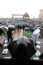 Onlookers shelter under umbrellas before the ceremony(Photo: Reuters)