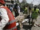 Rescue workers carry the body of a dead policeman at bomb blast site(Credit: Reuters)