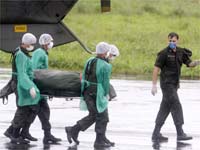 Brazilian Air Force carry the body of a victim of Air France Flight 447 (Credit: Reuters)