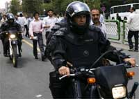 Riot police drive past Tehran University on 19 June 2009(Photo: Reuters)