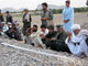 People pray at a mass grave of victims of air strikes in the village of Garni killed 5 May 2009(Photo: AFP)
