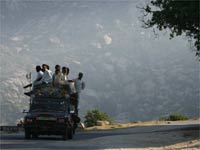 A truck full of men go through a mountain pass in Buner district(Credit: Reuters)