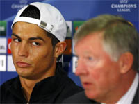 Manchester United's Cristiano Ronaldo (L) is seen looking at manager Alex Ferguson at a press conference(File photo: Reuters)