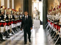 French President Nicolas Sarkozy walks between Republican Guards as he arrives at the Versailles Palace(Credit: Reuters)