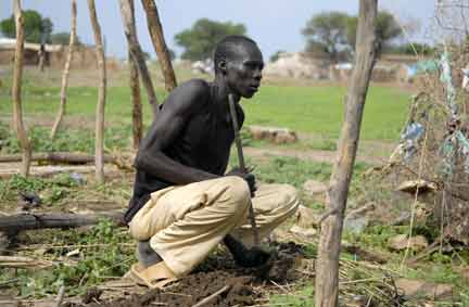 A man squats on the foundation of a house destroyed during fighting in Abyei town on 8 July(Photo: Reuters)