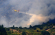 A Canadair fire-fighting aircraft drops water over burning trees near the Corsican village of Aullène(Photo: Reuters)