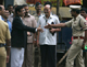 Police give public prosecutor Ujjwal Nikam (C, in black outfit) a hero's welcome after court proceedings Monday