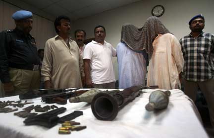 Police in Karachi show off weapons and alleged Taliban seized during a raid in the city on Sunday - they claim the men have close ties to Taliban chief Baitullah Mehsud(Photo: Reuters)