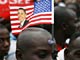 A man waits to catch a glimpse of US President Barack Obama in Accra(Credit: Reuters)