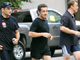 French President Nicolas Sarkozy, flanked by security officers, returns to his hotel after jogging in New York's Central Park Friday.(Photo: Reuters)