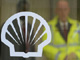 Workers are seen behind a logo for oil company Shell at its London offices Thursday. (Photo: Reuters)