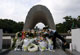 A woman places a flower for atomic bomb victims in front of a cenotaph at the Peace Memorial Park in Hiroshima, Japan on 5 August 2009(Photo: Reuters/Issei Kato)