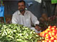 Shafir Khoar runs a vegetable stall at a busy crossroads. People don't have enough money to buy as much as they need, but he earns enough to look after his family