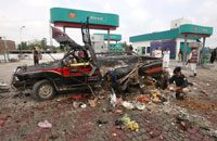 A policeman examines a vehicle at the site of an explosion in Charssada, 160 km from Pakistan's capital Islamabad, on 17 August, 2009. Six people were killed in the attack, which the Taliban claimed responsibility for. (Photo: Reuters/Ali Imam)