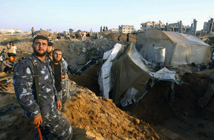 Members of Hamas's security forces guard a tunnel bombed by Israeli aircraft in Rafah, in the southern Gaza Strip, on 25 August, 2009. (Photo: Reuters/Ibraheem Abu Mustafa)