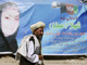 A man walks past a campaign banner for presidential candidate Shahla Ata in Kabul August on Sunday, 2009.(Photo: Reuters)