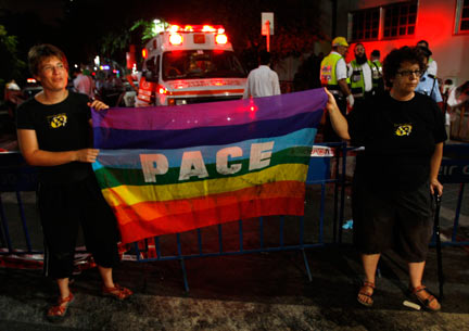 Israelis hold a gay pride flag near the scene of the shooting i(Photo: Reuters)