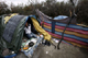 An Afghan migrant cooks in his makeshift shelter in woods near the port of Calais on 23 September, 2009(Photo: Reuters)