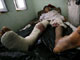 An injured Afghan villager lies in hospital after Friday's NATO air strike(Credit: Reuters)