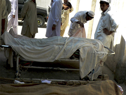 Men stand near the bodies of those killed in an earlier Taliban attack in Bannu, in the north-west frontiers province, on Saturday(Photo: Reuters)