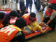 A survivor is helped onto a stretcher after the Superferry9 disaster(Credit: Reuters)