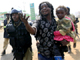 Ugandan police arrest a man carrying a child in a suburb of Kampala on 11 September(Photo: Reuters)