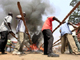 Burning tyres are cleared from the roads in Kampala on 11 September(Photo: Reuters)