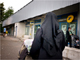 A woman wearing a burka walks down the street in Venissieux, near Lyon.(Photo: AFP)
